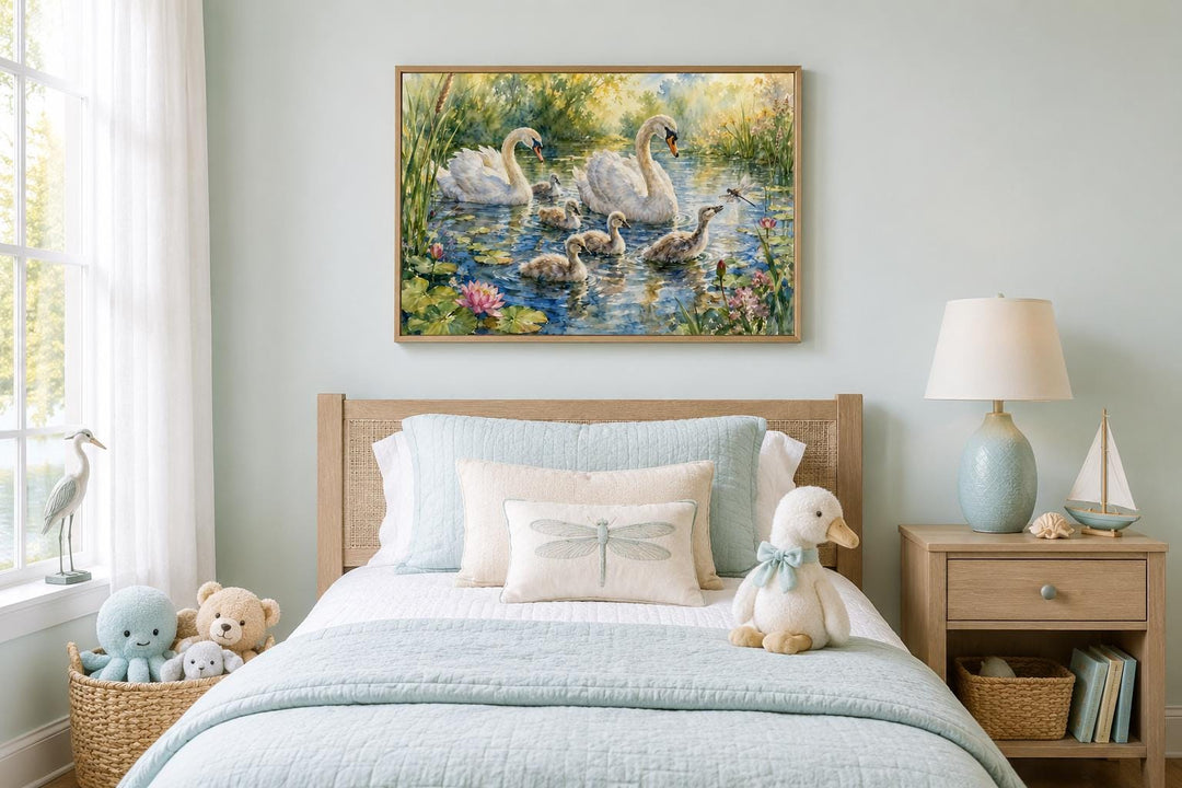 Swan family with baby cygnets canvas wall art hanging above a child's bed in a nursery.