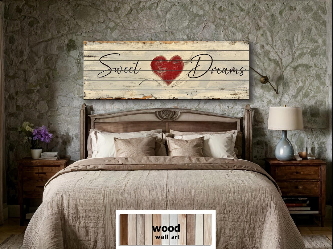 Rustic wood wall art featuring Sweet Dreams text and a red heart above a farmhouse-style bed.