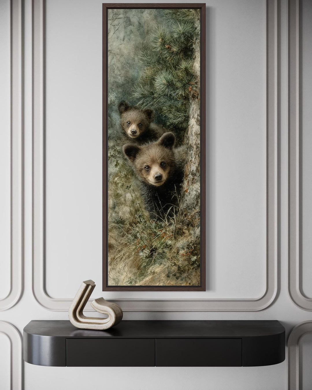 Tall narrow canvas wall art featuring two baby bear cubs peeking from behind a pine tree.