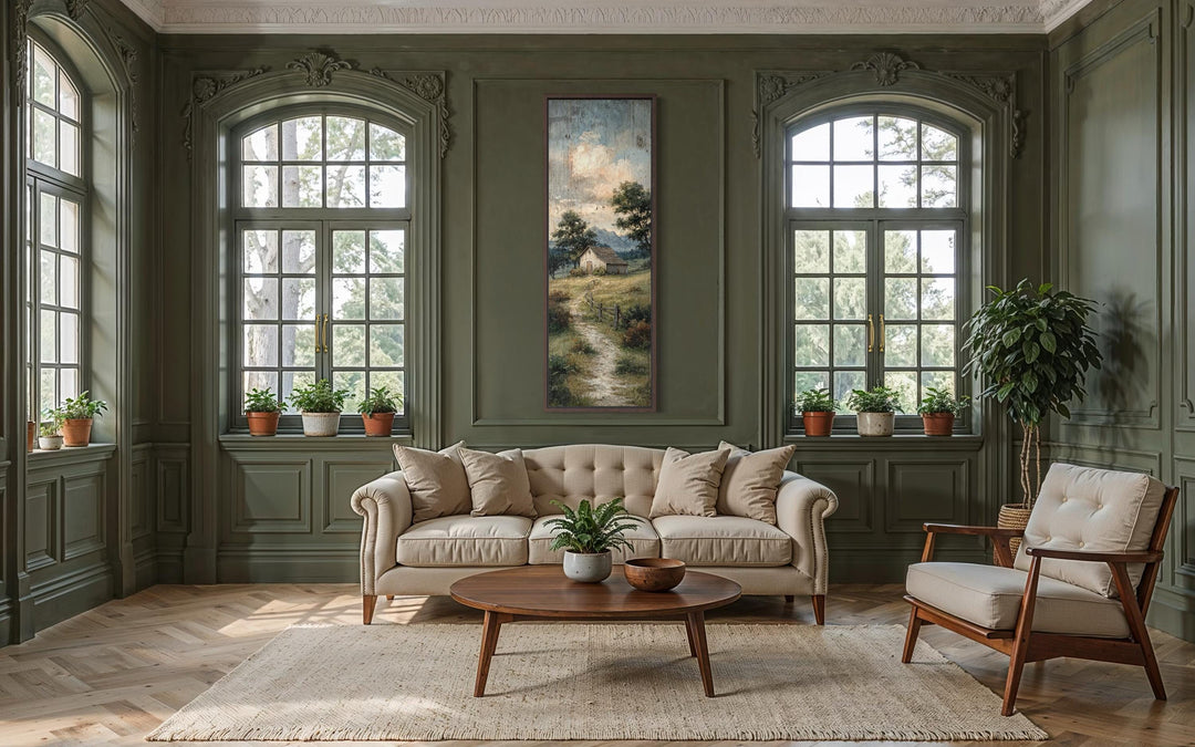 Tall narrow canvas wall art of a rustic barn and country path in a green paneled living room.