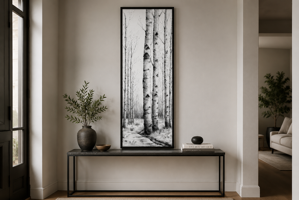 Tall narrow vertical framed canvas wall art featuring black and white birch trees in a winter scene.