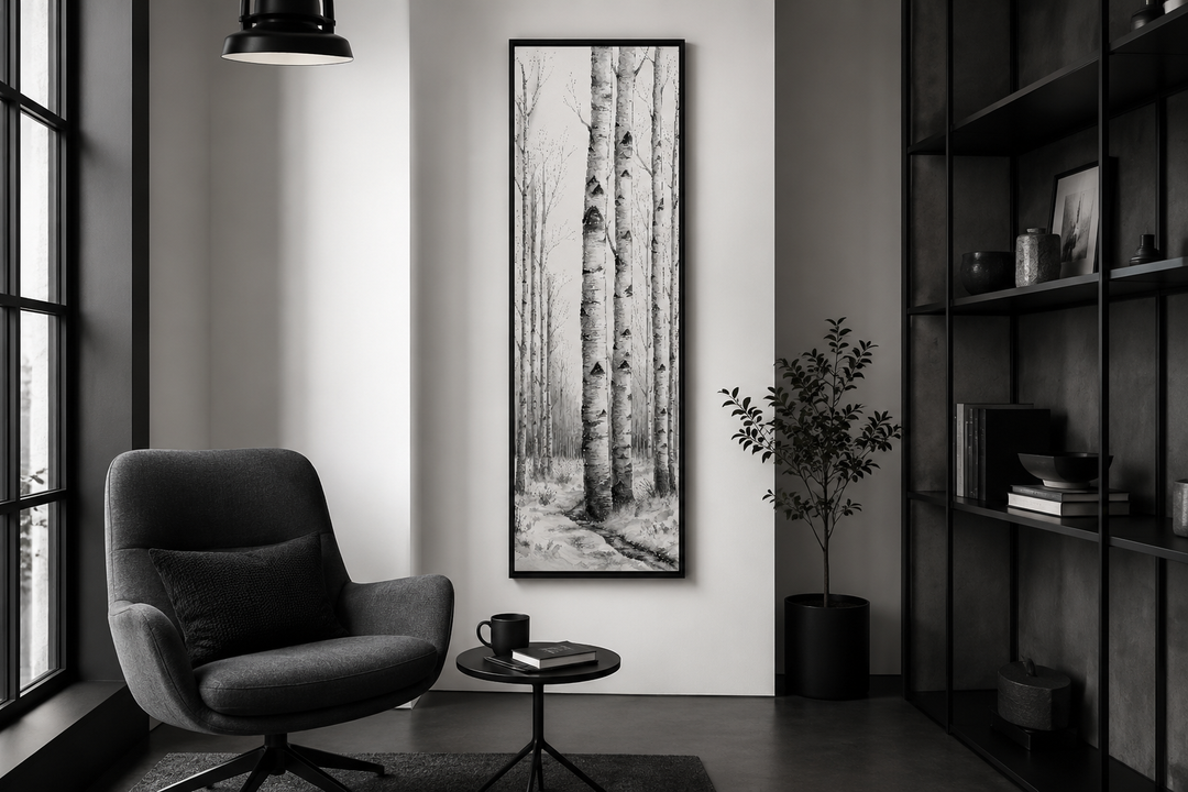 Tall narrow vertical framed canvas wall art featuring black and white birch trees in a winter scene.