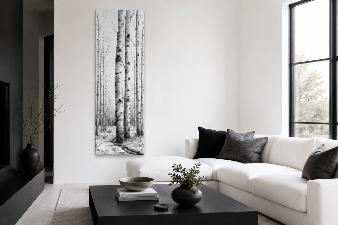 Tall narrow black and white vertical framed canvas wall art featuring birch trees in a winter scene.