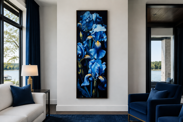 Tall narrow framed canvas wall art featuring blue irises on a black background in a modern room.