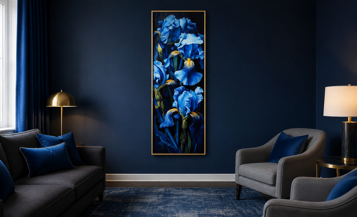 Tall narrow framed canvas wall art featuring blue irises on a black background in a navy blue room.