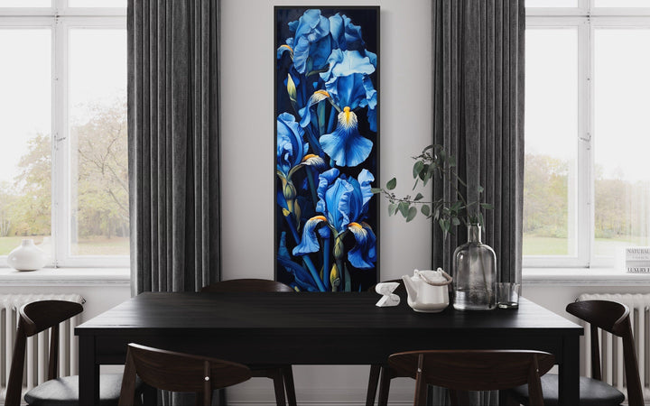 Tall narrow vertical framed canvas wall art featuring blue irises on a black background.