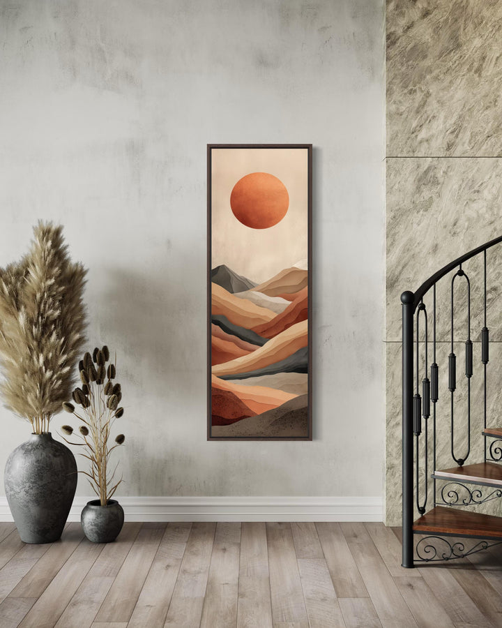Vertical canvas print of a terracotta desert landscape with a sun in a tall narrow frame.