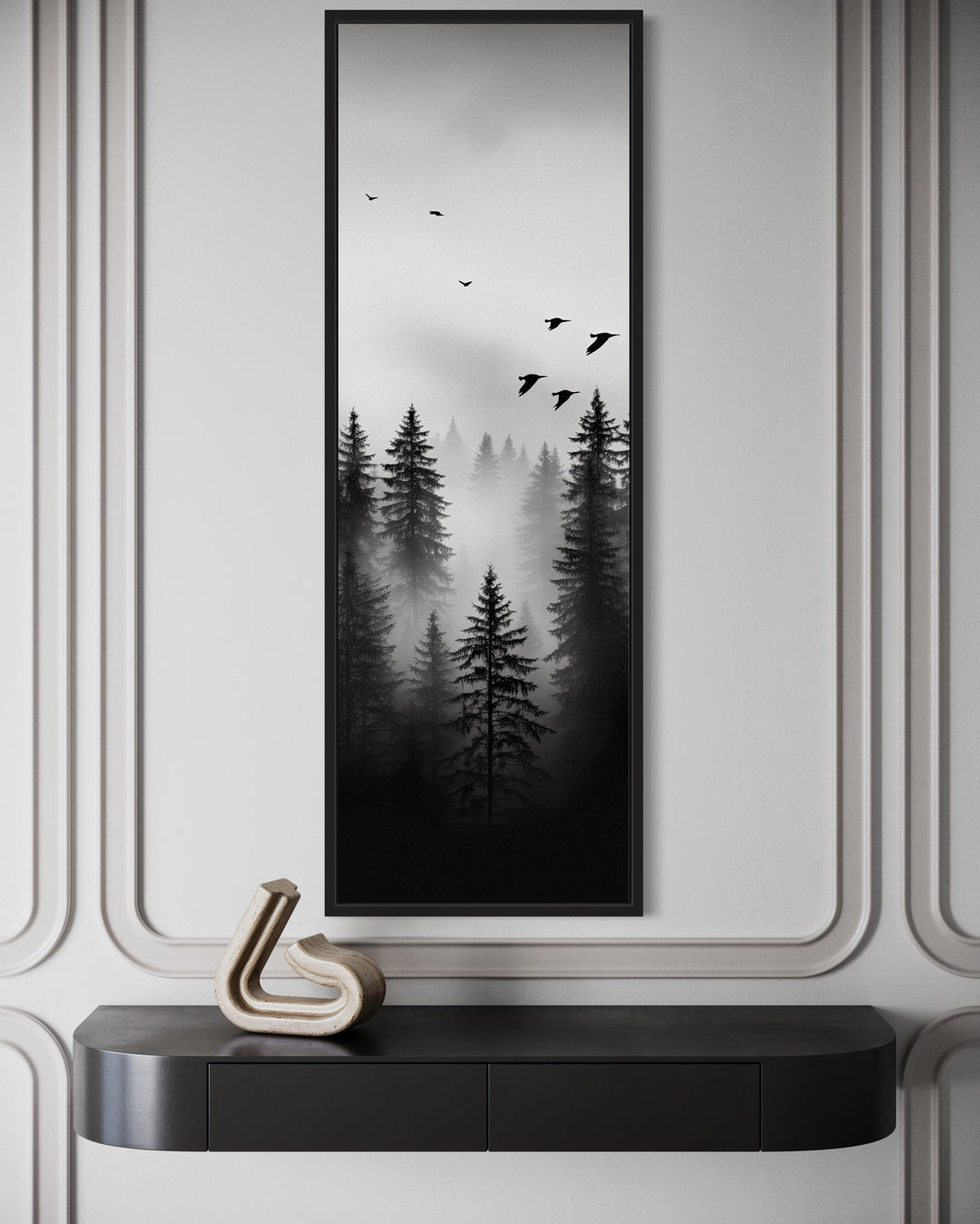 Tall narrow vertical framed canvas art of a foggy black and white forest with birds flying above.