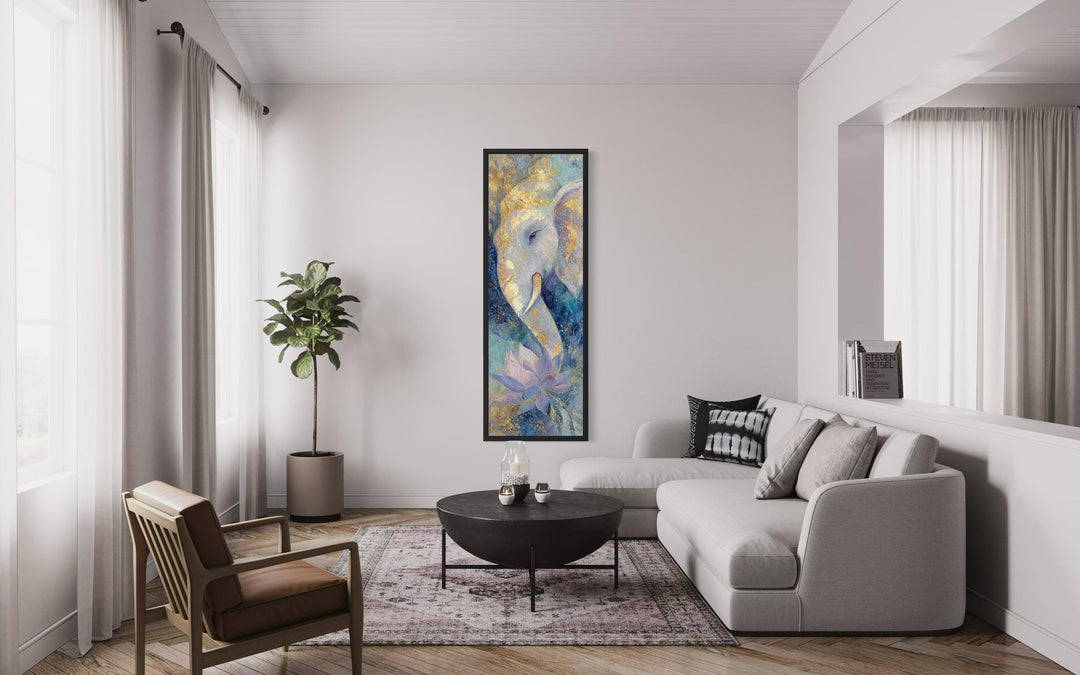 Tall narrow blue and gold Ganesh wall art with a lotus flower hangs in a modern living room.