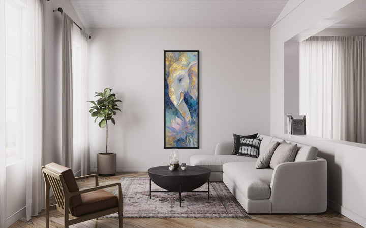 Tall narrow blue and gold Ganesh wall art with a lotus flower hangs in a modern living room.