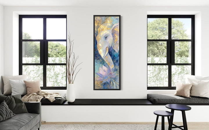 Tall narrow canvas art of a blue and gold Ganesh with a lotus flower in a modern living room.