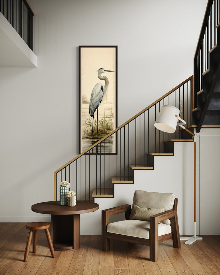 Tall narrow framed canvas wall art featuring a great egret in a coastal landscape.