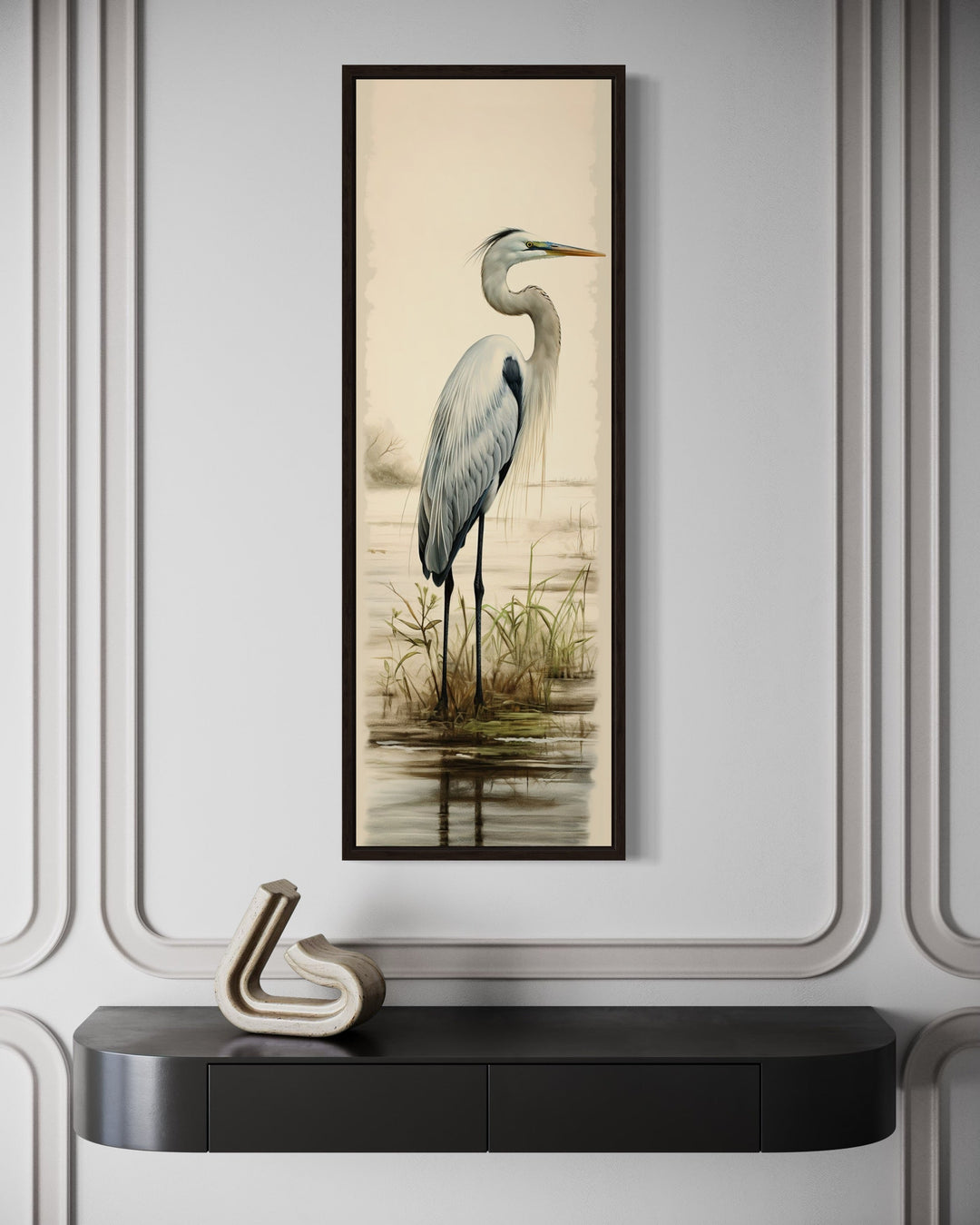 Tall narrow framed canvas wall art featuring a great egret standing in a coastal marsh.
