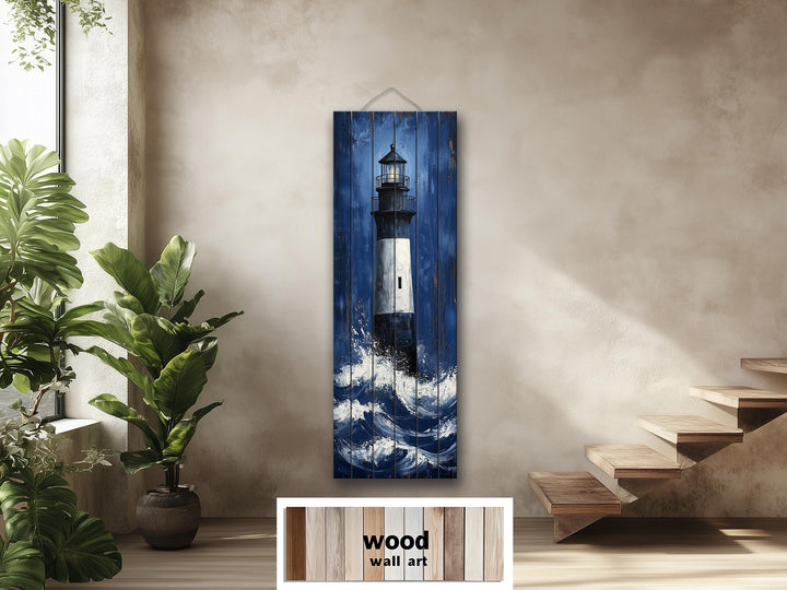 Tall narrow vertical wood wall art featuring a lighthouse in ocean waves on a neutral wall.