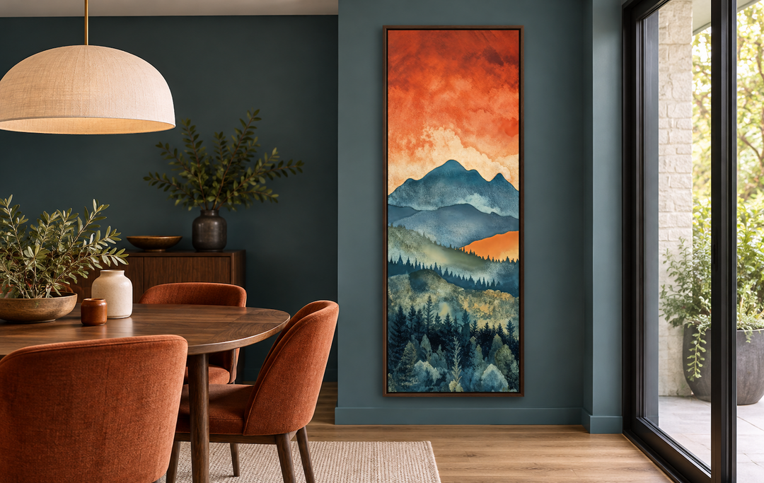 Tall narrow vertical canvas art of a mountain forest landscape under a sunset sky in a dining room.