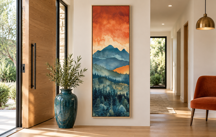 Tall narrow vertical canvas art of a mountain forest landscape under a sunset sky in an entryway.