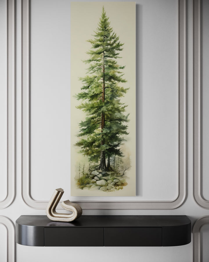 Tall narrow pine tree vertical framed canvas wall art hanging above a black console table.