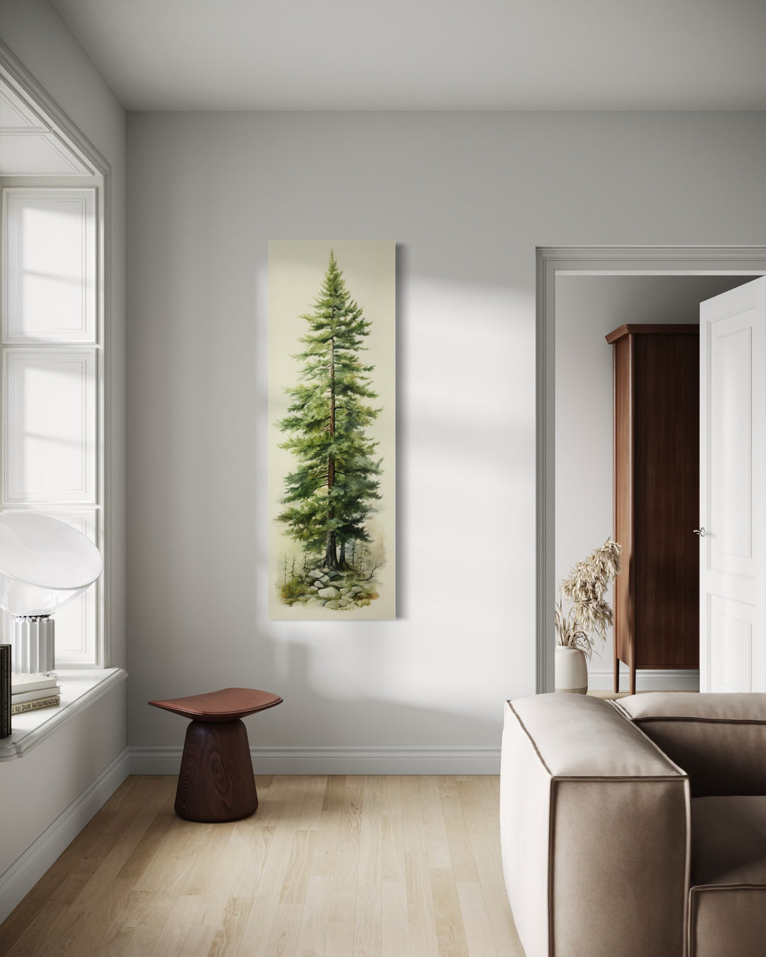 Tall narrow pine tree vertical framed canvas wall art hanging in a minimalist living room.