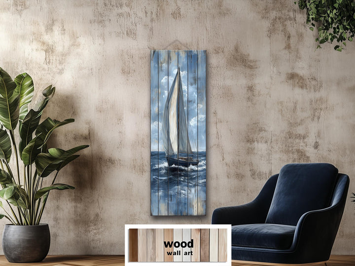 Tall narrow sailboat painting on distressed wood planks, featuring a nautical blue and white palette.
