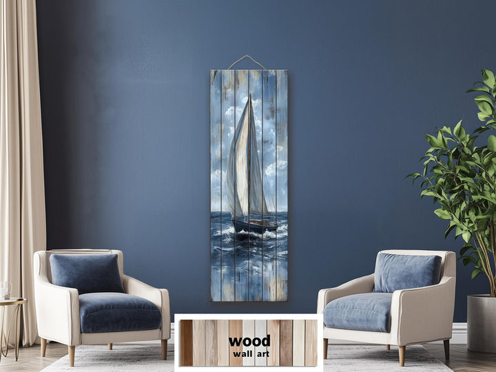 Tall narrow sailboat painting on distressed wood planks, featuring a nautical blue and white palette.