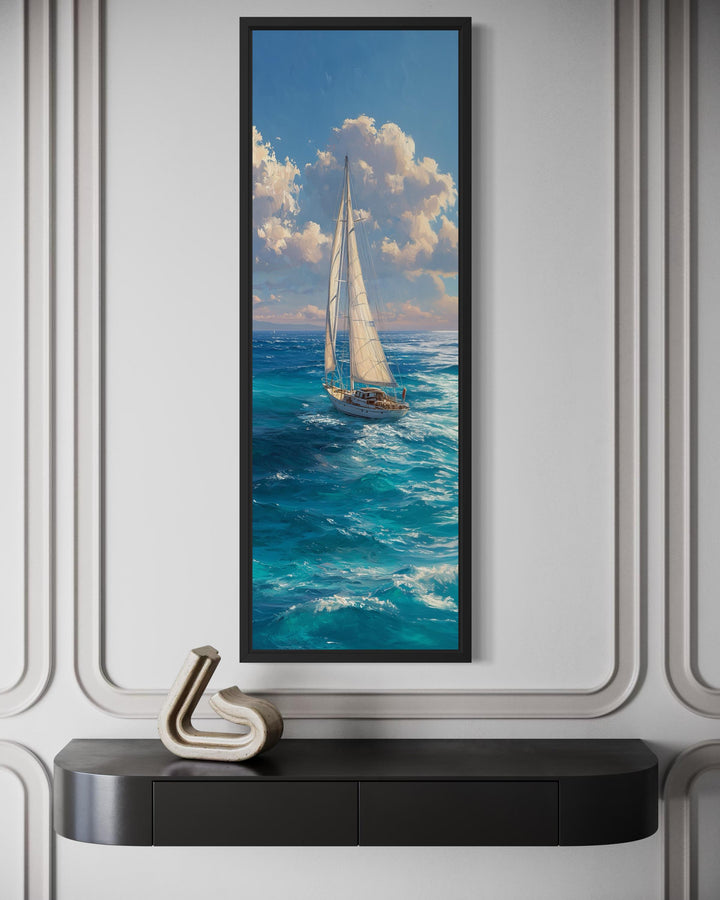 Tall narrow vertical canvas print of a sailboat on a blue ocean under a cloudy sky.