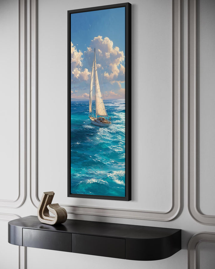 Tall narrow vertical canvas print of a sailboat on a blue ocean under a cloudy sky.