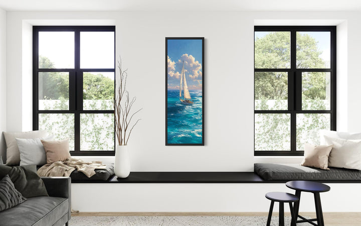 Tall narrow vertical canvas print of a sailboat on a blue ocean under a cloudy sky.