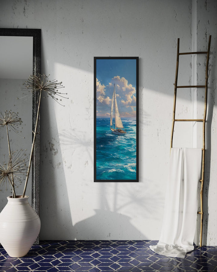 Tall narrow vertical canvas print of a sailboat on a deep blue ocean under a cloudy sky.