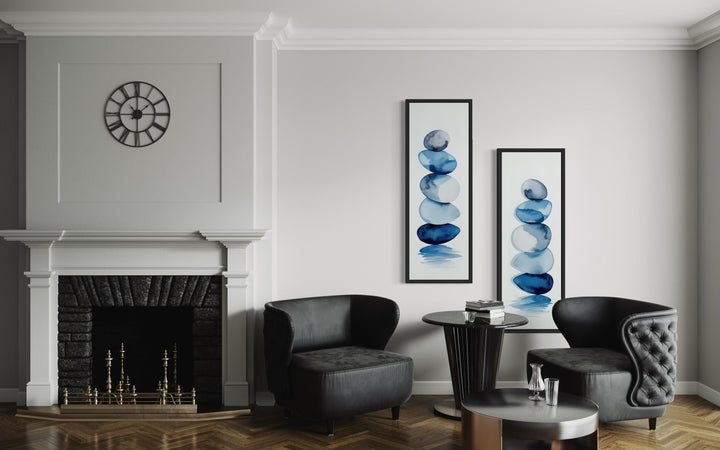 Set of two tall narrow canvas prints featuring blue watercolor stacked zen stones on white walls.