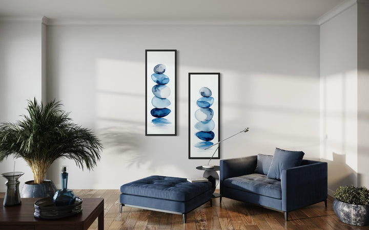 Two tall, narrow canvas prints featuring stacked blue watercolor zen stones on a white background.