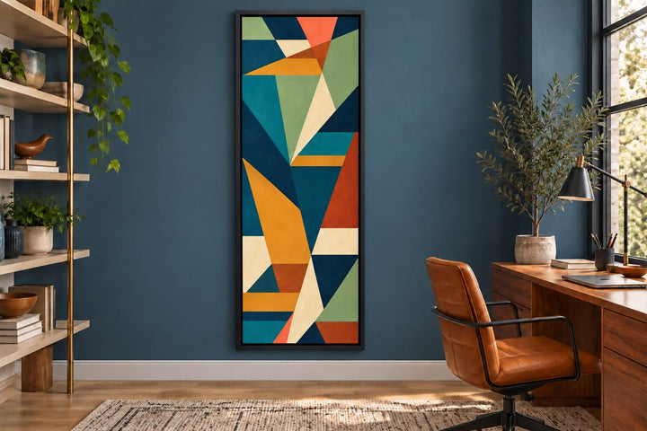 Tall narrow vertical mid-century modern geometric abstract canvas wall art in a blue office setting.