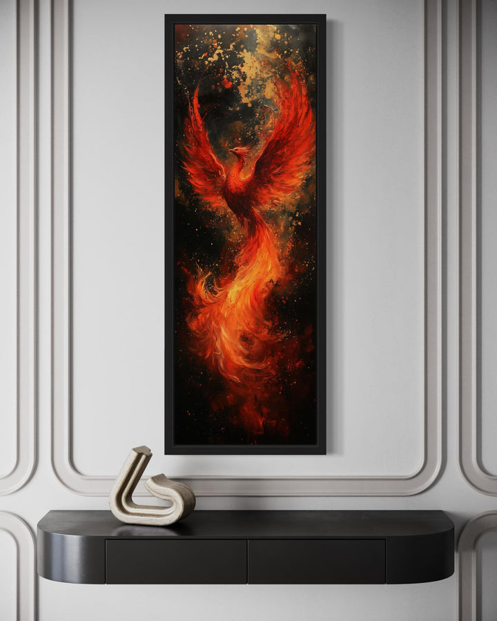 Tall narrow framed canvas wall art featuring a fiery red and orange phoenix rising from flames.