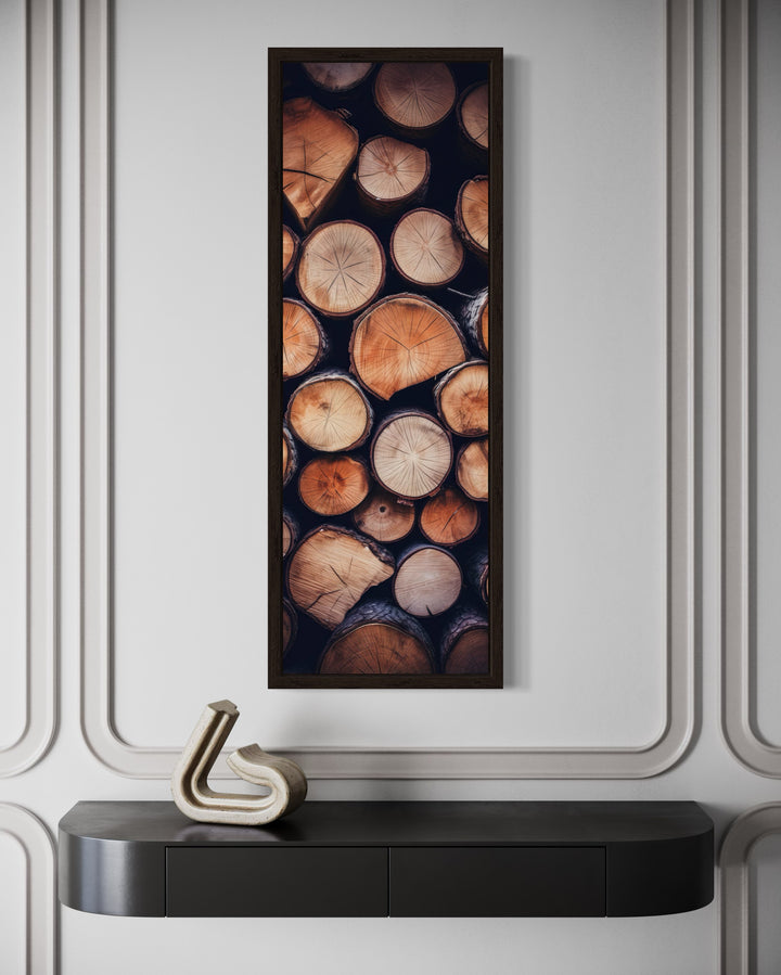 Tall narrow framed canvas wall art featuring a vertical stack of rustic wood logs with grain rings.