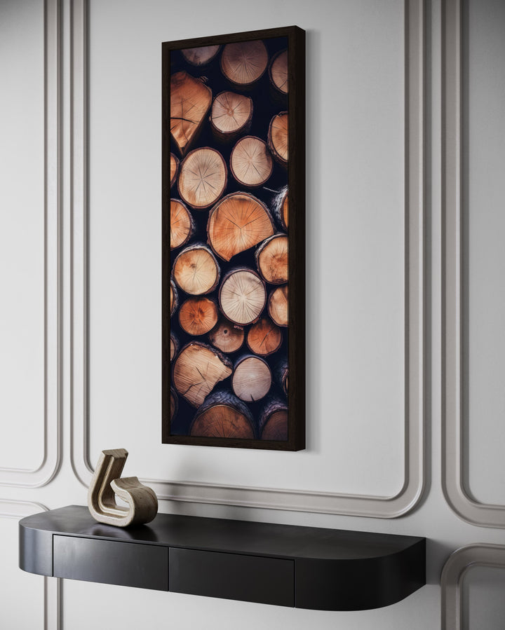 Tall narrow framed canvas wall art featuring a vertical stack of rustic woodgrain rings.