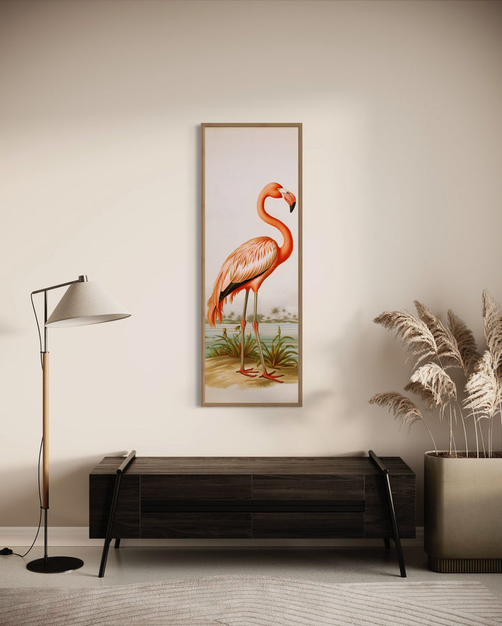 Tall narrow vintage flamingo vertical framed canvas wall art hanging above a dark wood sideboard.