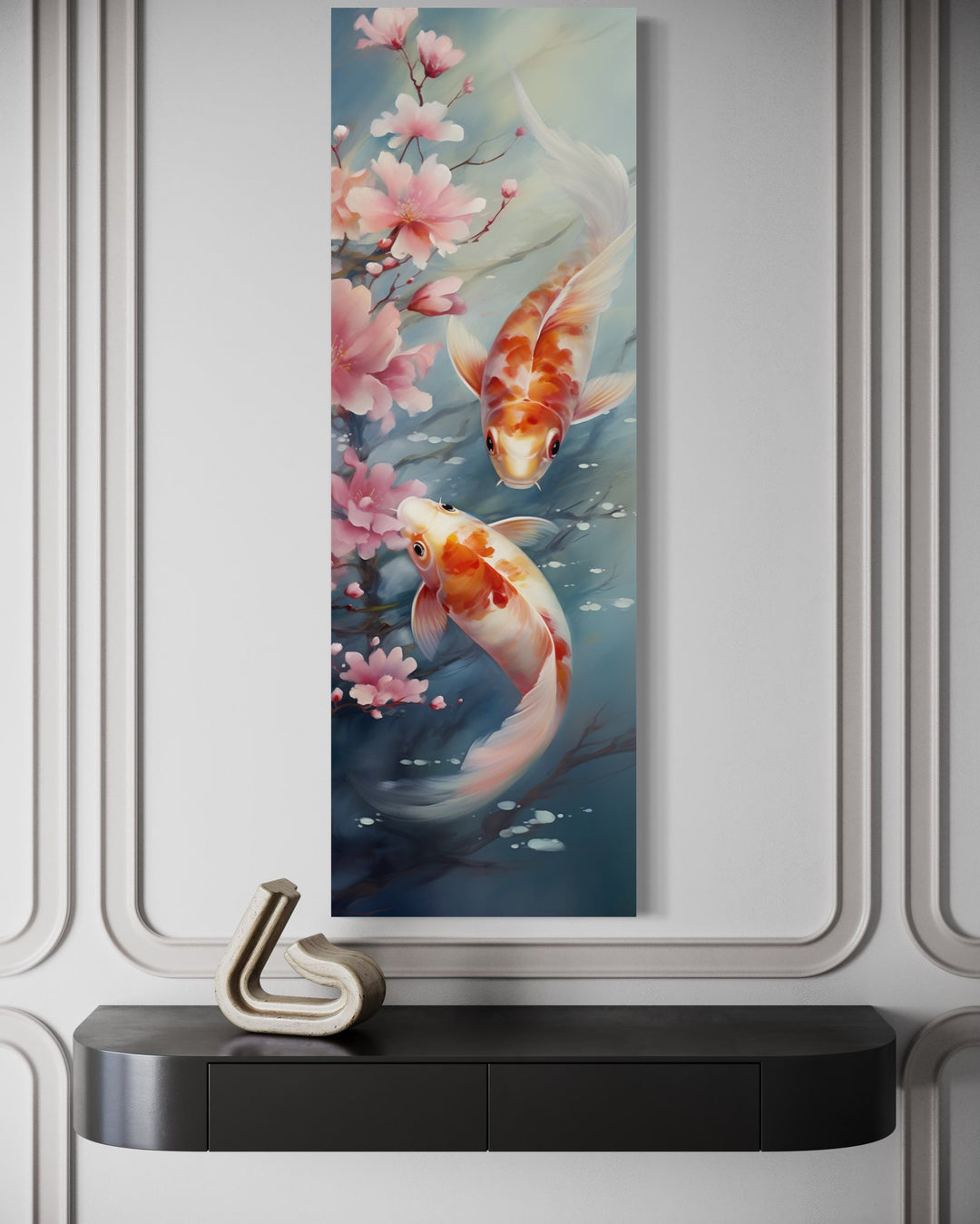 Tall narrow vertical canvas art of two koi fish swimming among pink cherry blossoms on a white wall.
