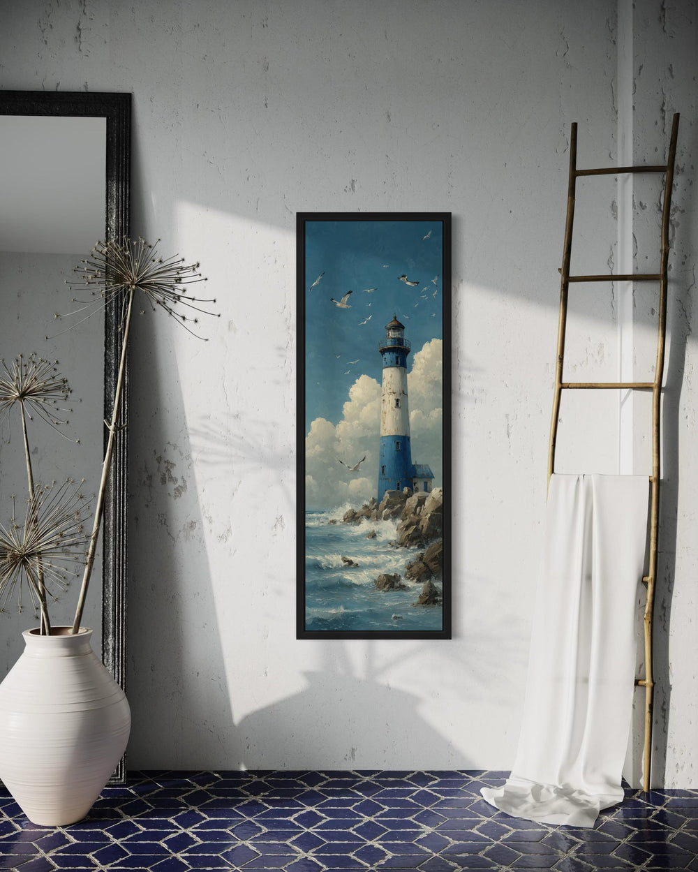 Tall narrow vertical canvas painting of a blue and white lighthouse on a rocky shore with seagulls.