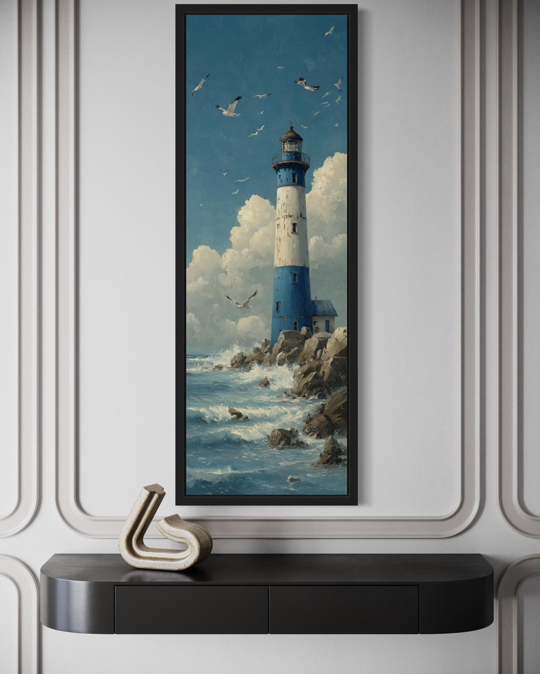 Tall slim lighthouse canvas wall art in a vertical narrow frame above a black console table.