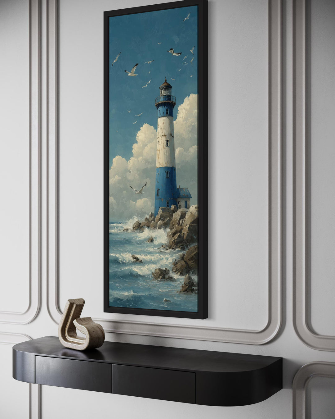 Tall slim lighthouse canvas wall art in a black frame above a black console table.