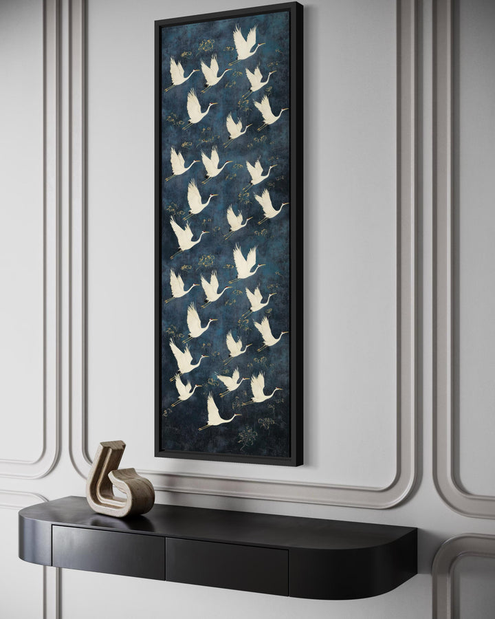 Tall vertical navy blue framed canvas wall art featuring a pattern of white flying cranes.