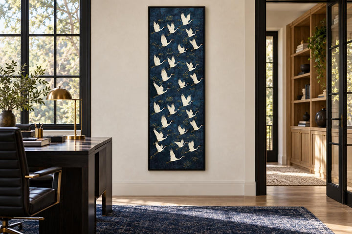 Tall vertical framed canvas wall art featuring white flying cranes on a navy blue background.