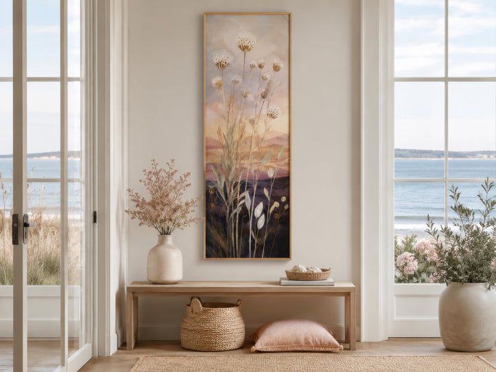 Tall vertical canvas art of wildflowers and grasses against a gold and purple sunset sky.