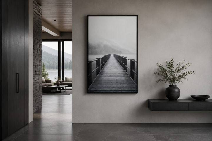 Vertical framed canvas wall art of a foggy black and white lake landscape with a wooden dock.