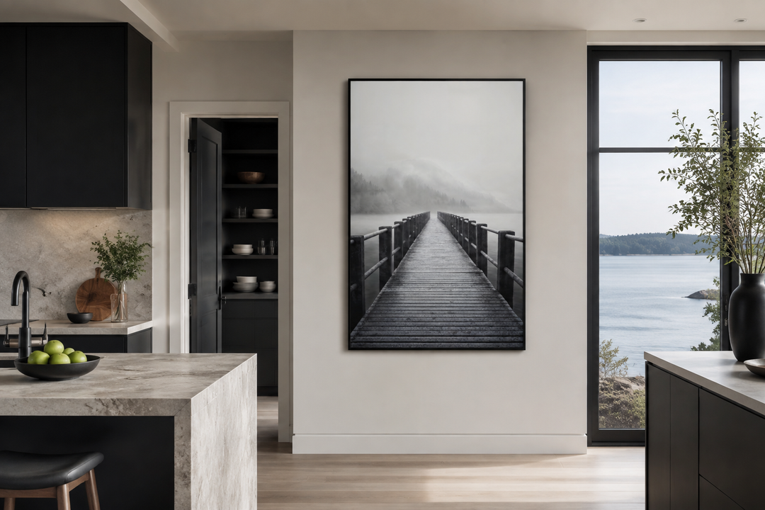 Foggy black and white lake landscape with a dock framed canvas wall art in a modern kitchen.