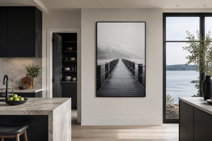 Foggy black and white lake landscape with a dock framed canvas wall art in a modern kitchen.