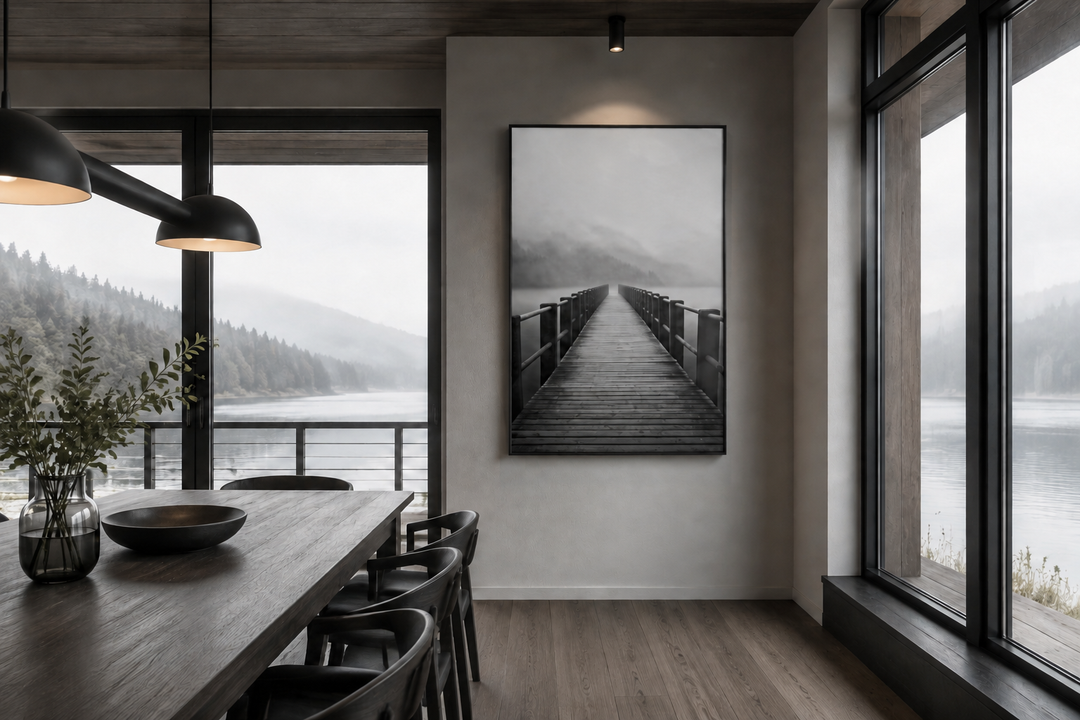 Foggy black and white lake landscape with a dock framed canvas wall art in a modern dining room.