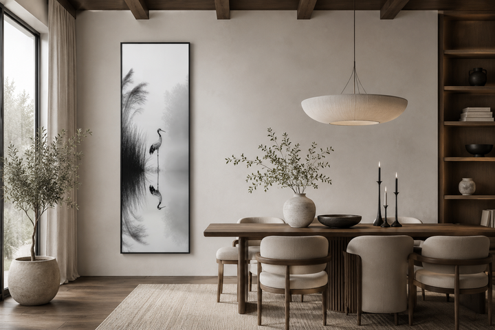 Tall narrow black and white Japanese crane wall art in a minimalist zen dining room.