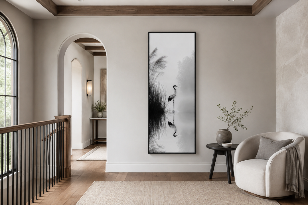 Tall narrow black and white Japanese crane wall art in a minimalist zen living room.