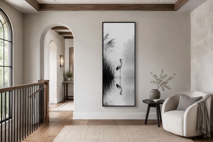 Tall narrow black and white Japanese crane wall art in a minimalist zen living room.