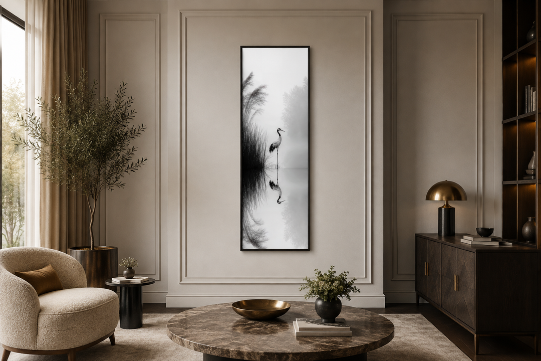 Tall narrow black and white Japanese crane wall art in a zen-style living room.